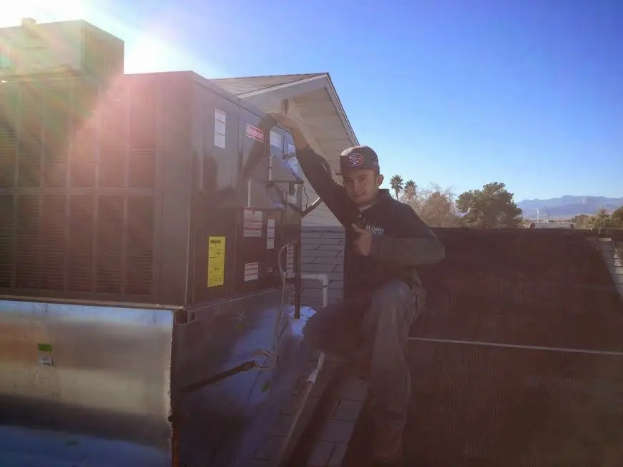 HVAC technician performing HVAC Inspection on a rooftop unit in Laguna Niguel